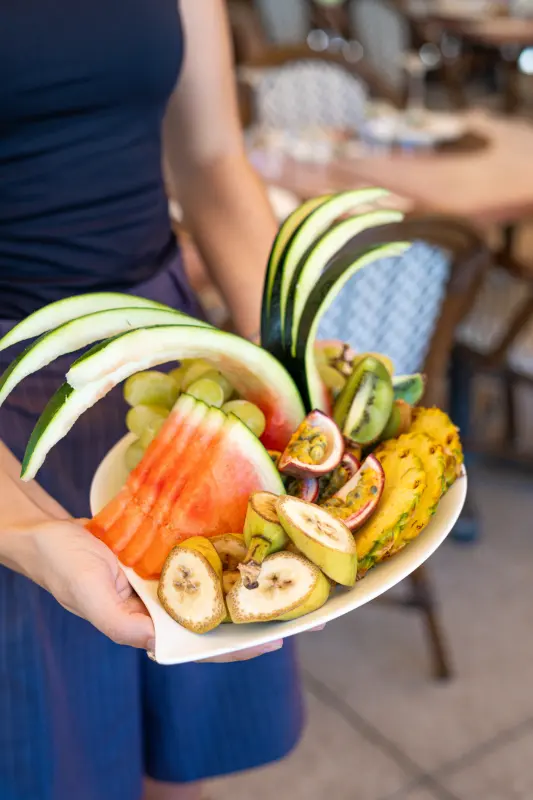 Plateau de fruits frais présenté à deux mains