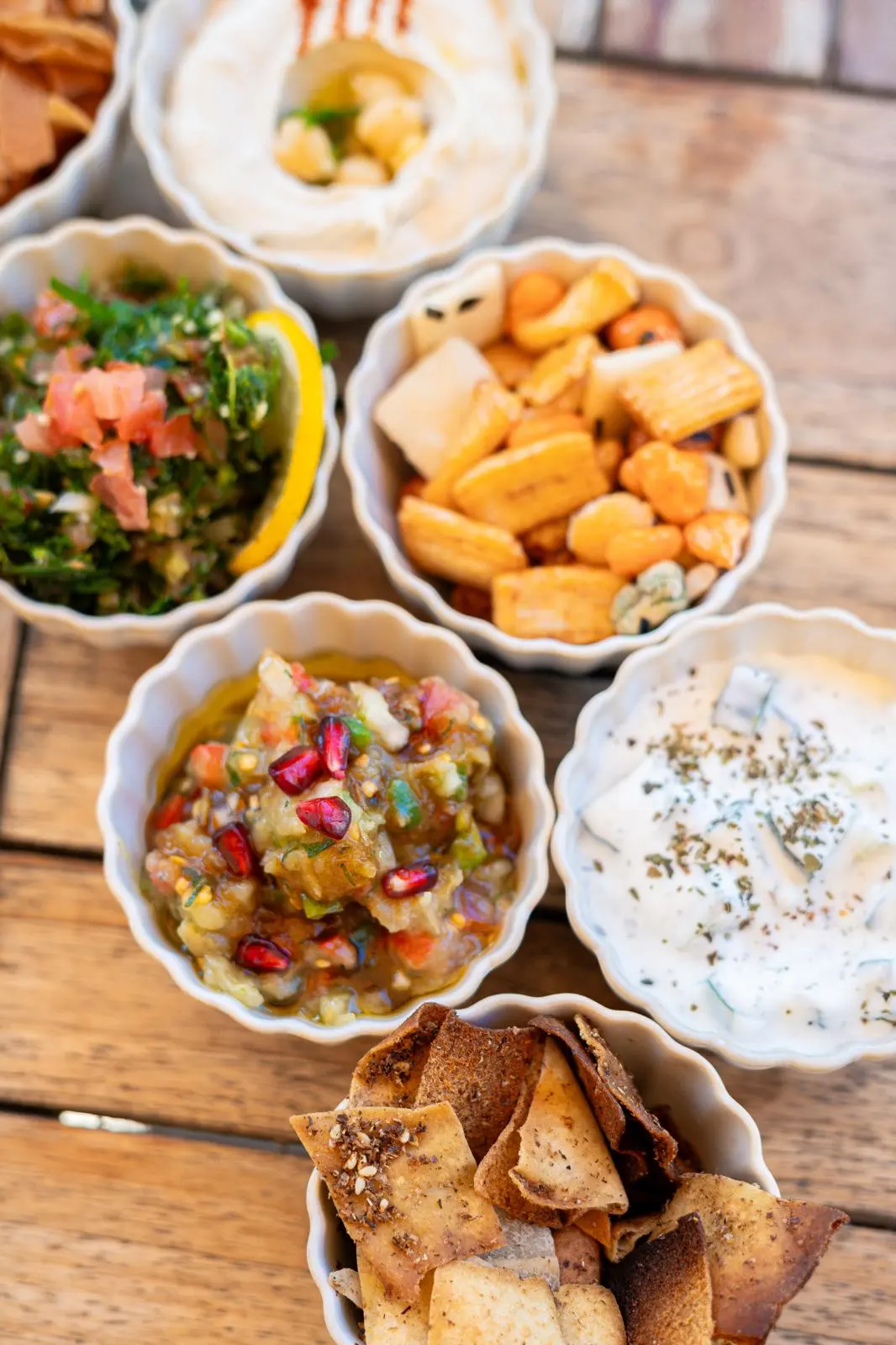 Assortiment de mezzés froids en coupelles, hommos, taboulé, moutabal